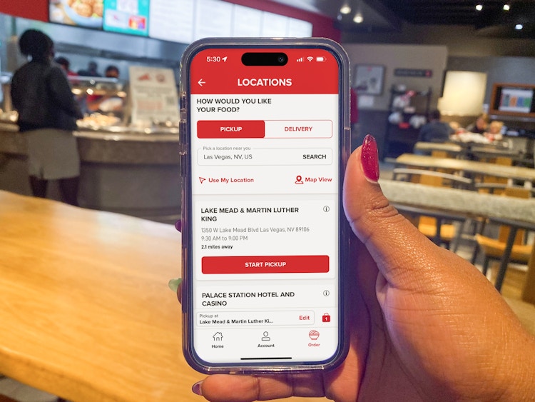Someone holding a phone displaying the Panda Express app making an order for pickup