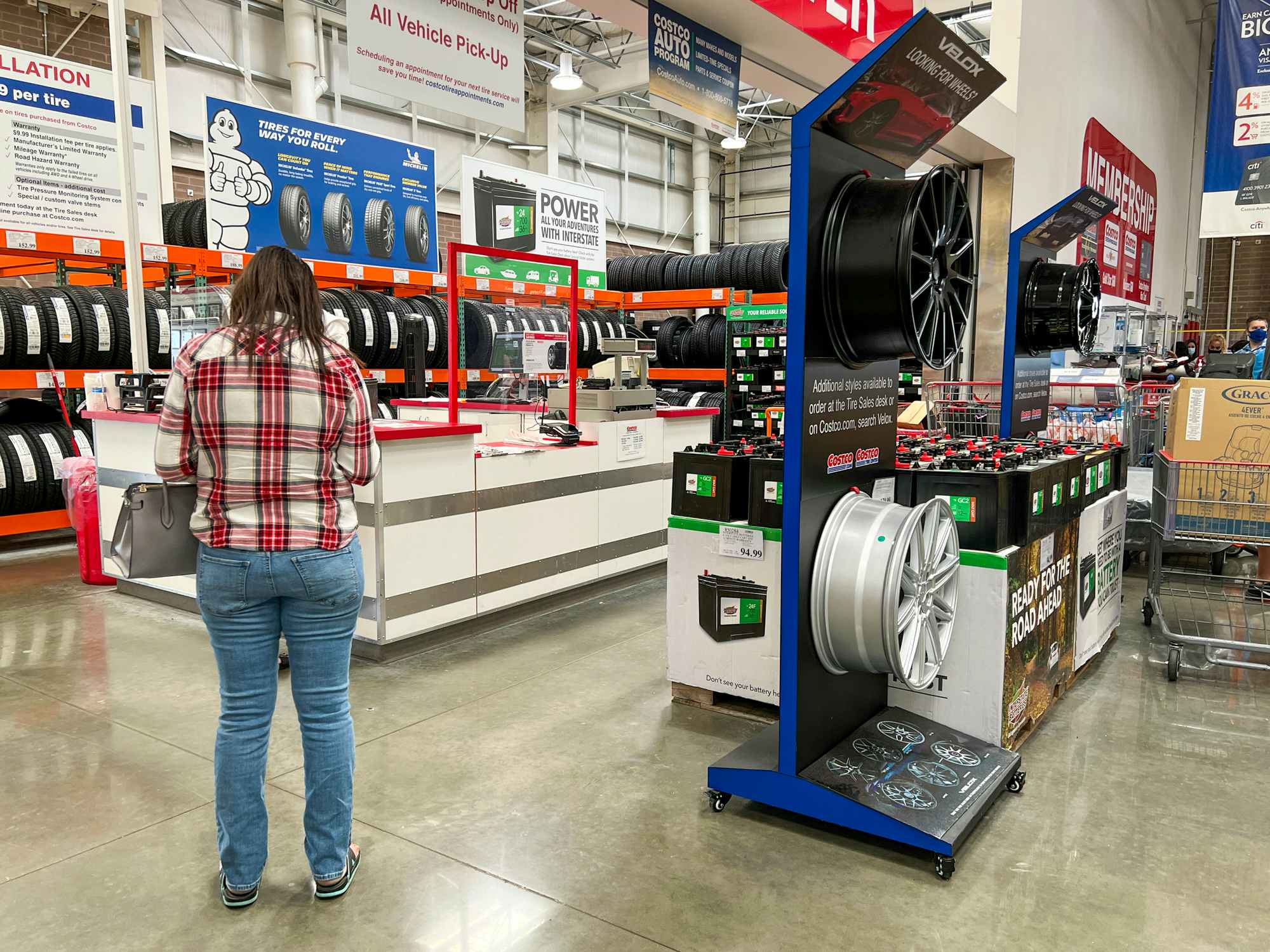 A customer standing in the tire center at Costco