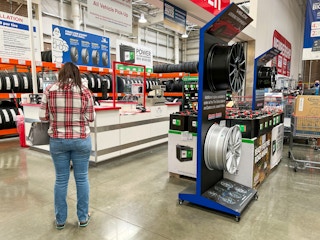 A customer standing in the tire center at Costco