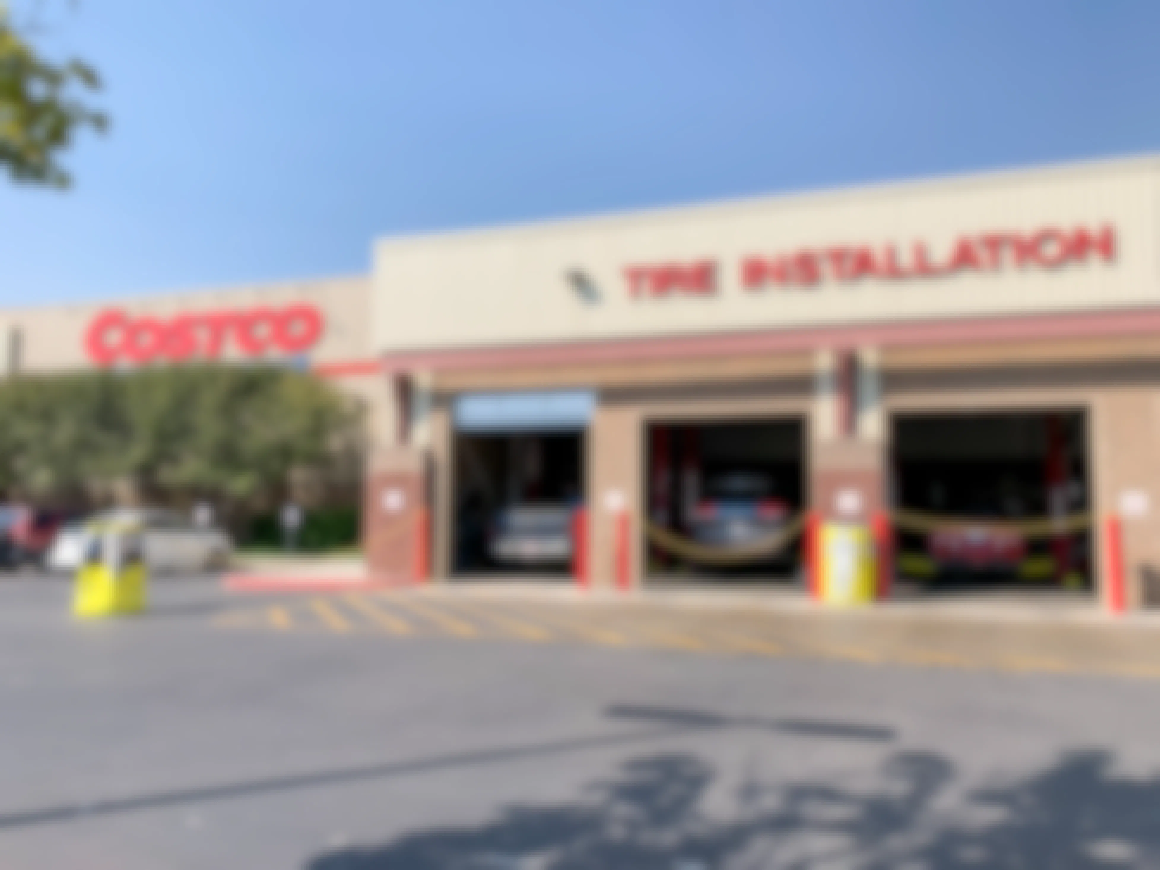 The outside of a Costco Tire Installation garage with cars inside.