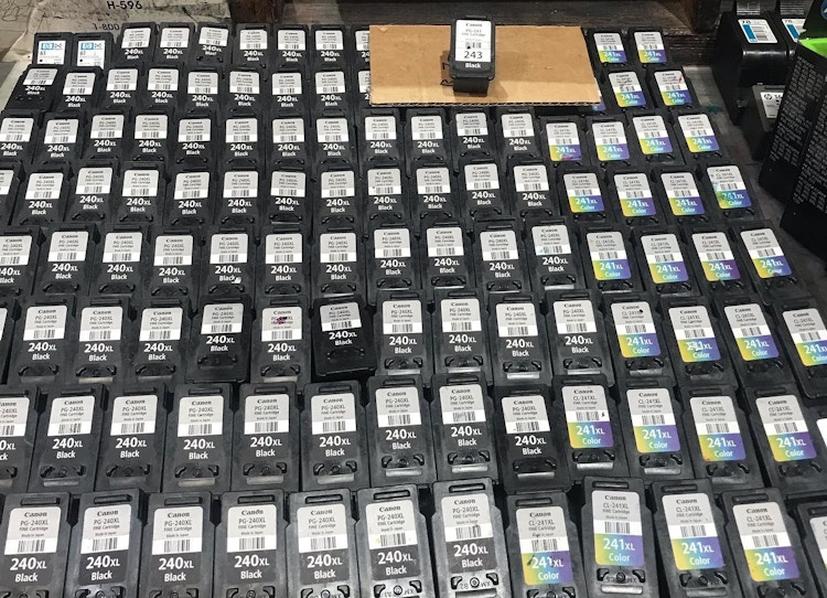 A bunch of used ink cartridges on a table