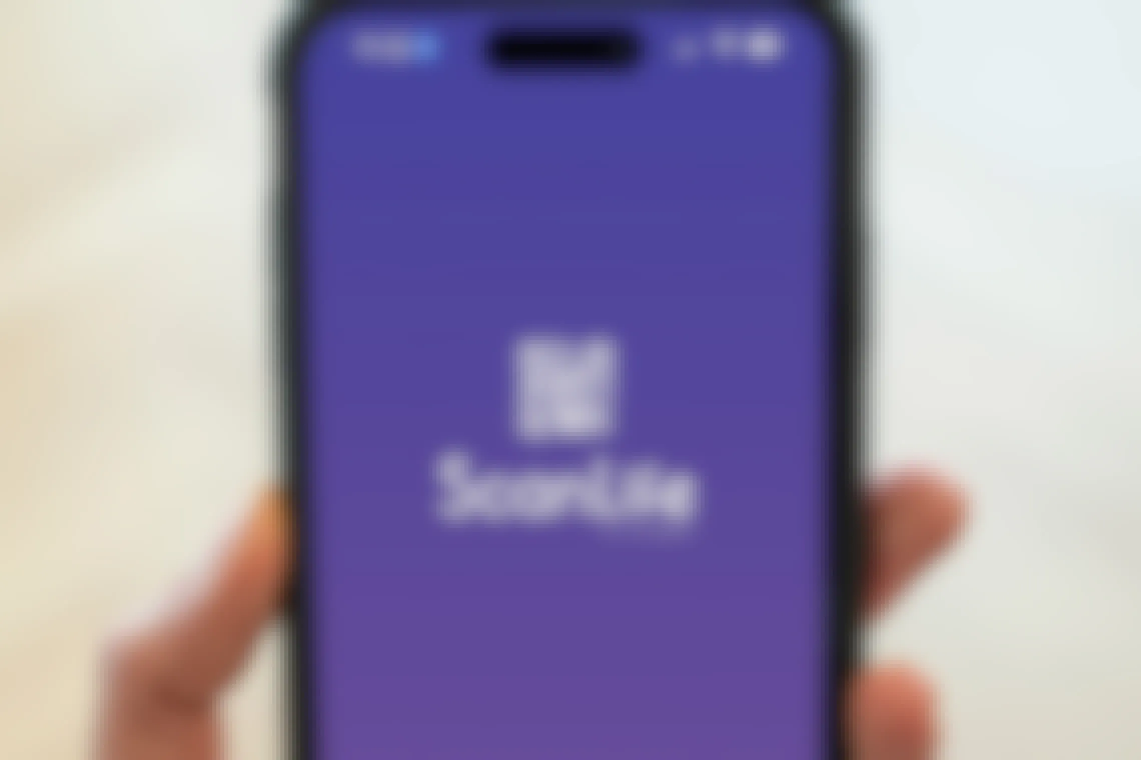 Someone holding up a phone displaying the Scan Life app start screen