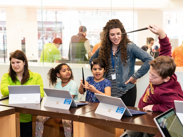Children working on their computers at a Microsoft summer camp