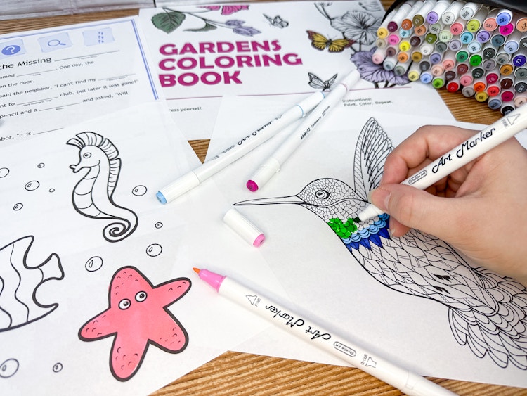 Coloring pages and activity print outs from the Microsoft Virtual camp printables, with art markers and someone coloring in a hummingbird coloring page