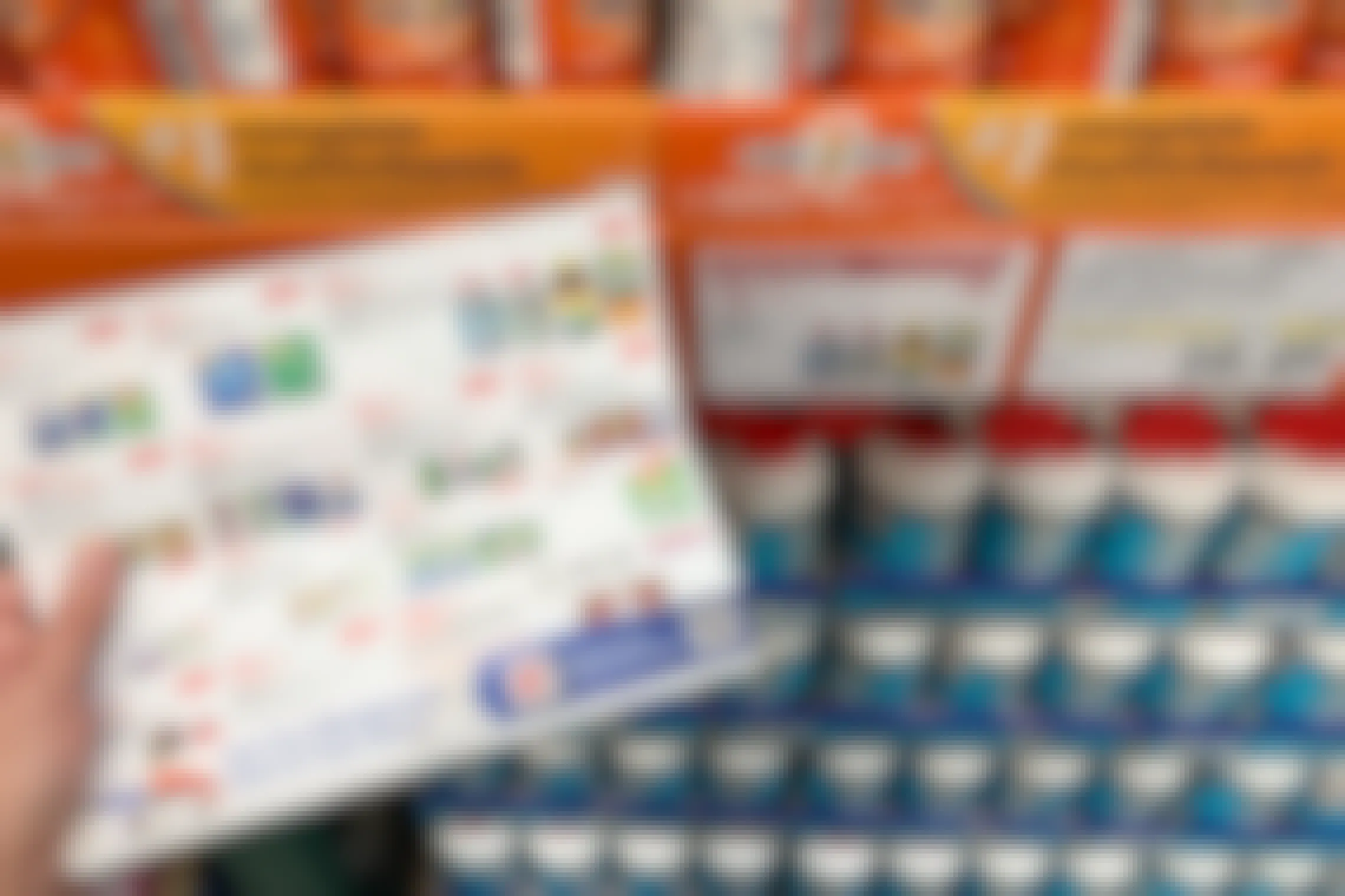 Costco coupon book with Kirkland vitamins on the page and the shelf behind it
