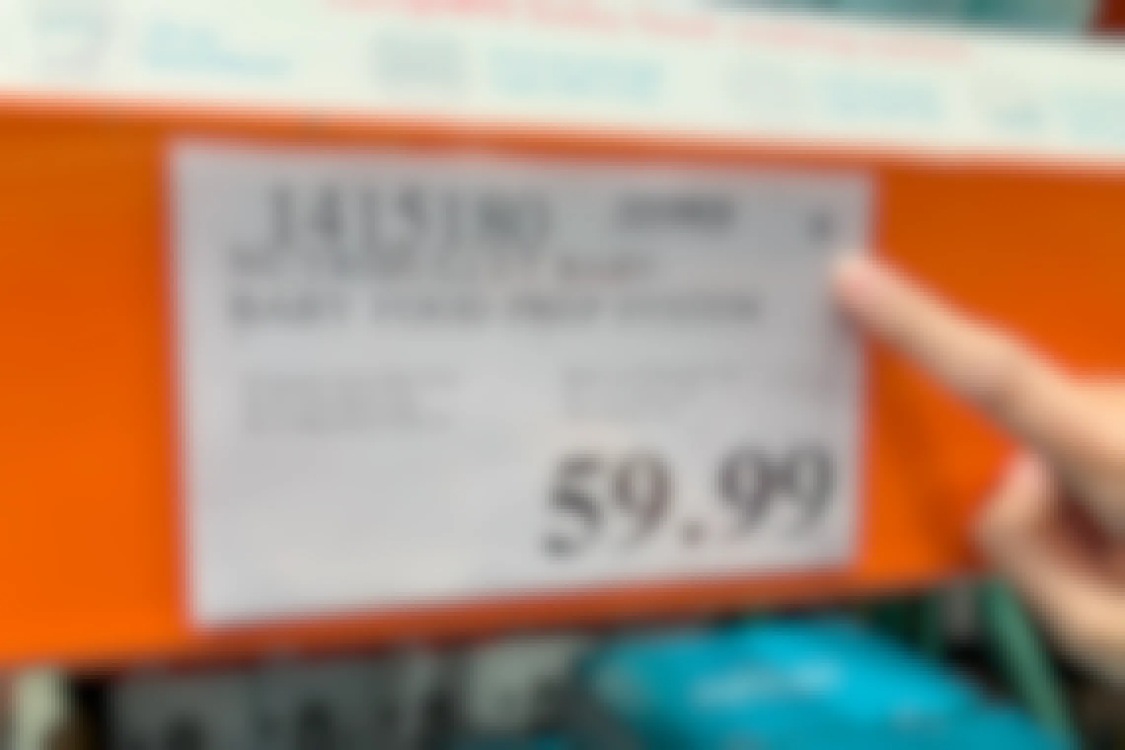 Person pointing out Asterisk on a price tag at Costco