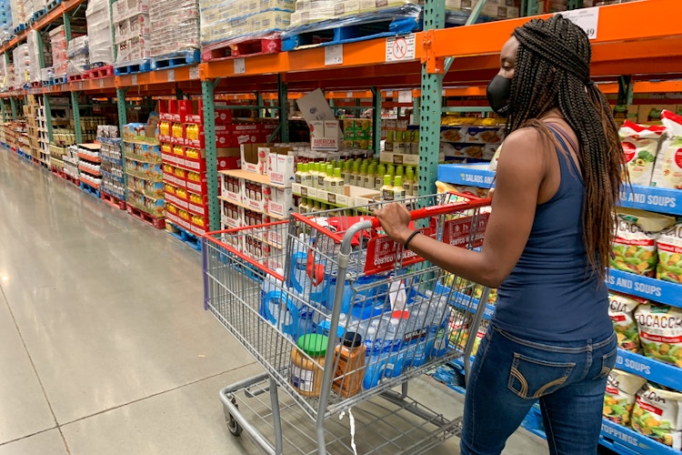 A woman pushing a shopping cart in Costco