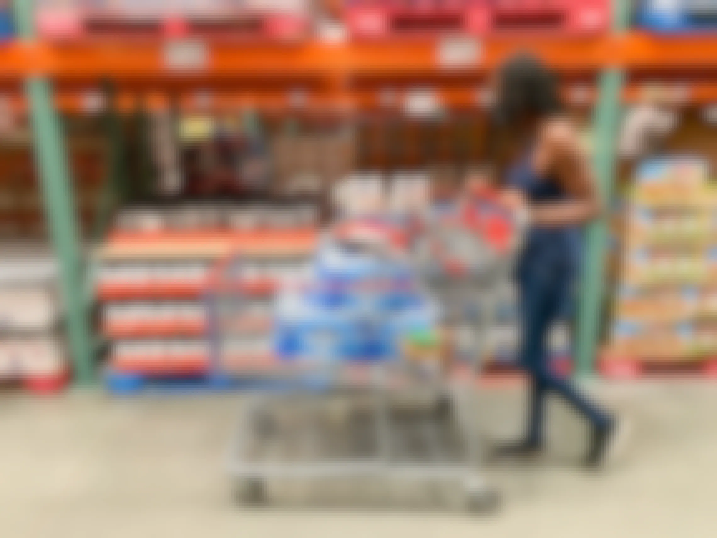 A woman pushing a shopping cart in Costco