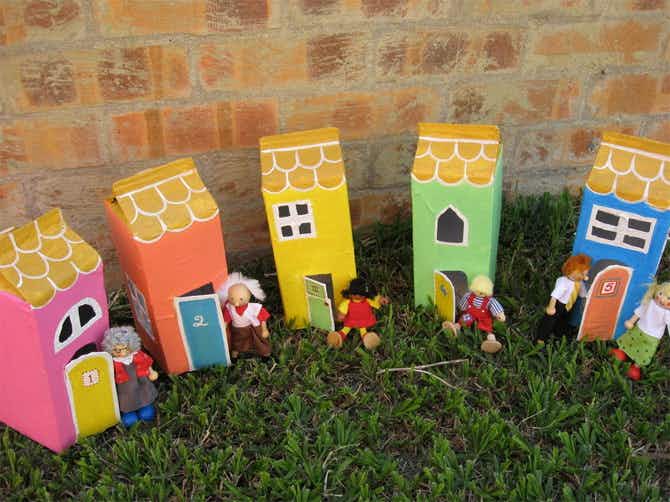 Five cardboard carton dollhouses.