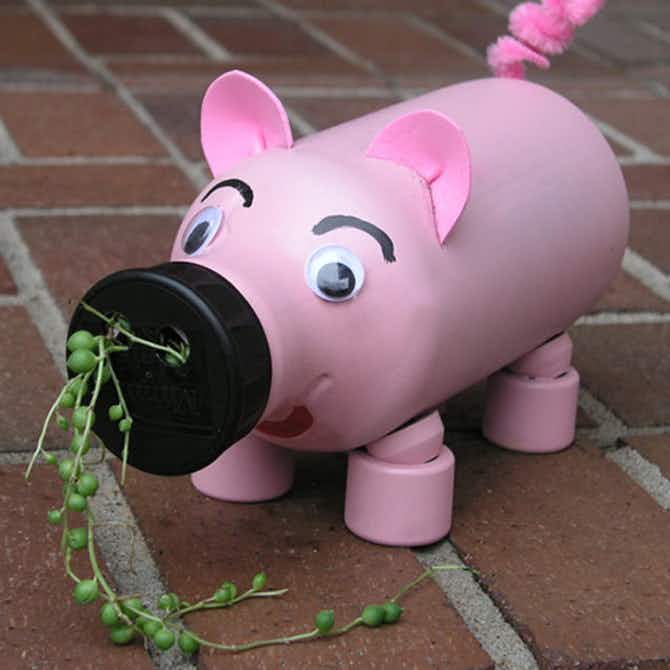A pig shaped planter made out of a plastic bottle.