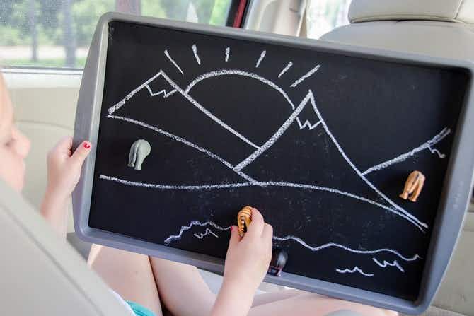 Attach chalkboard paper to an old baking tray for a portable, magnetic play board.