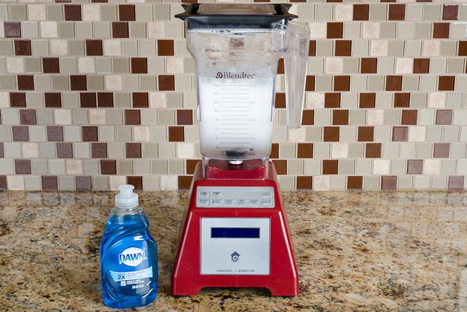 soap and water added to a dirty blender and blend it clean.