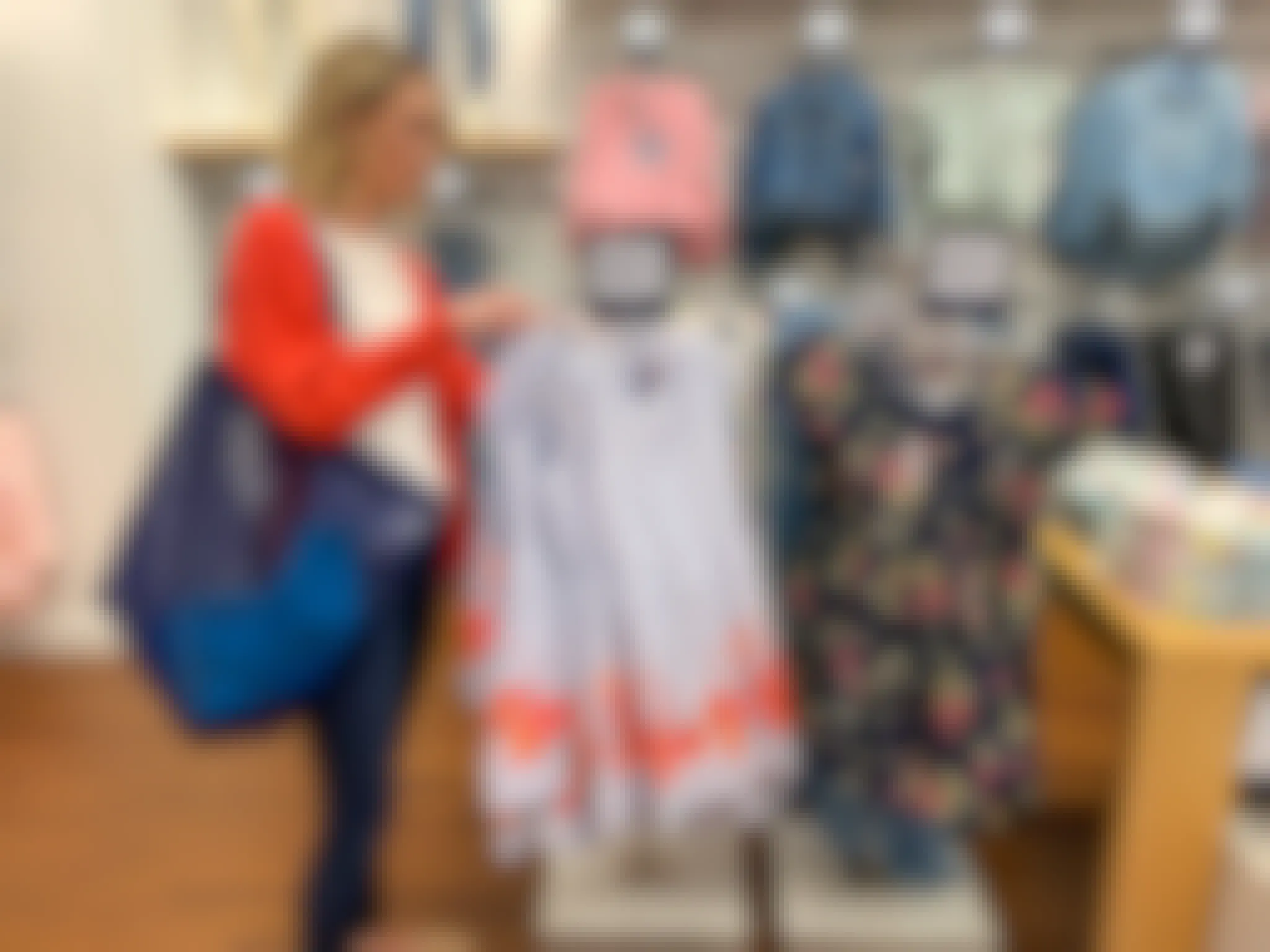 A woman looking at girl spring clothes and dresses.