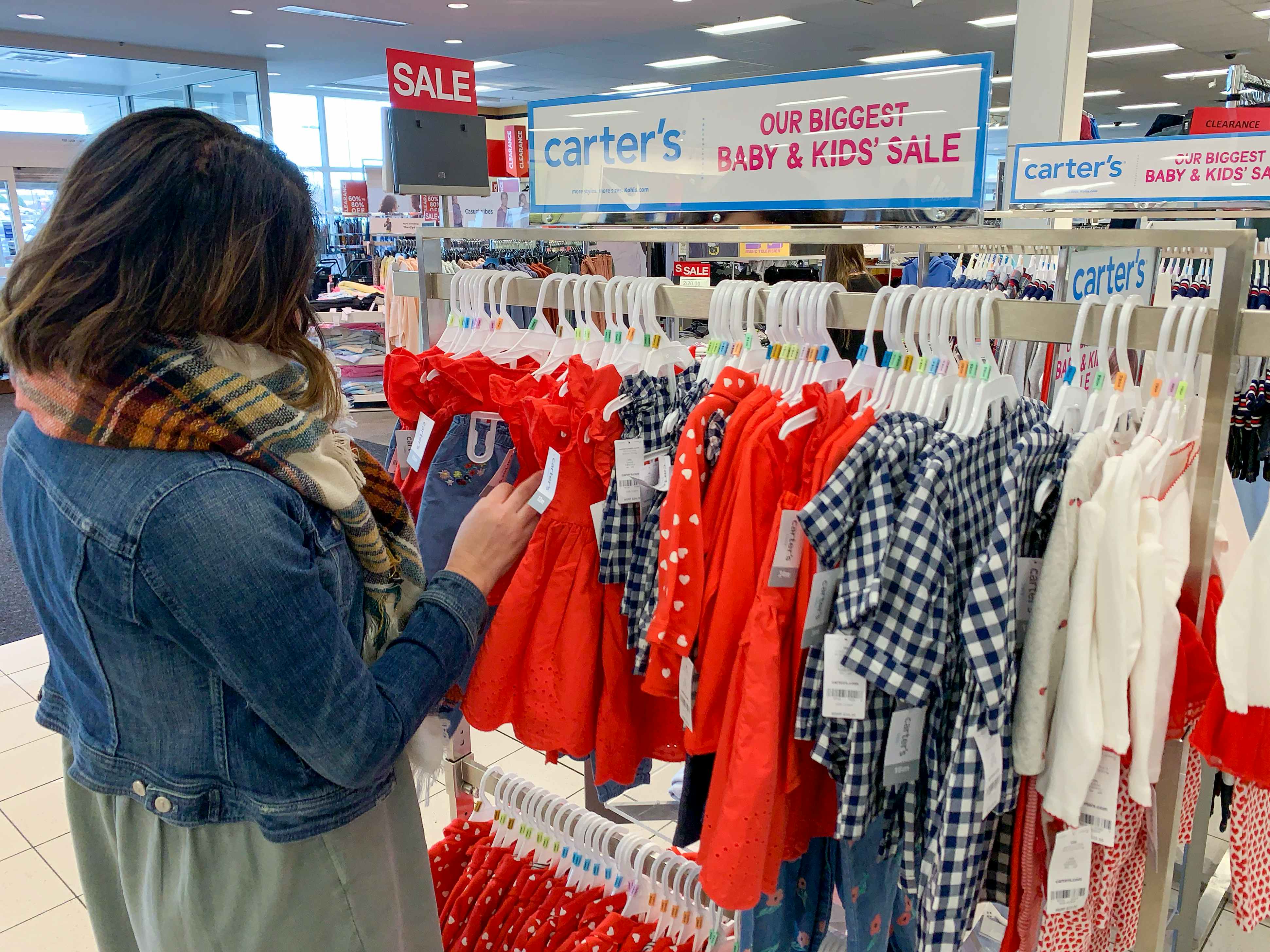 A woman looking through Carter's baby clothes