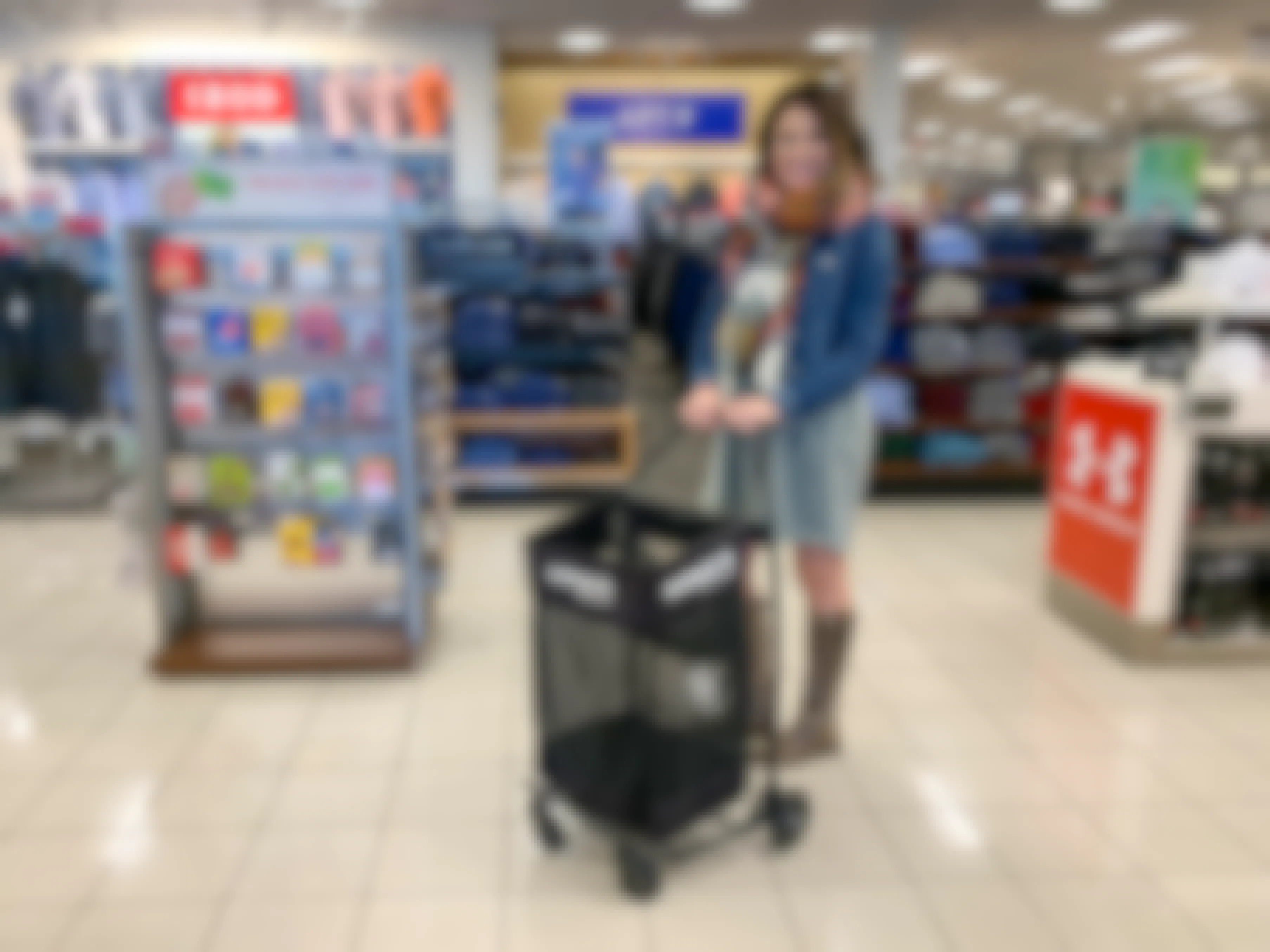 A woman standing in Kohl's with a shopping basket