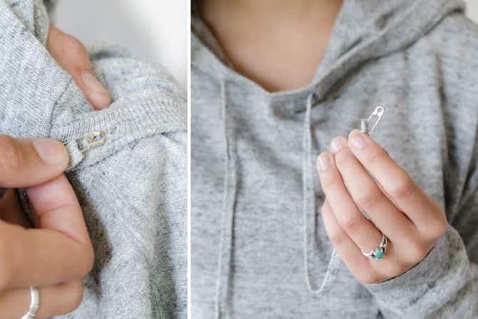 Restring a hoodie by attaching a safety pin to the end and using it as a guide.