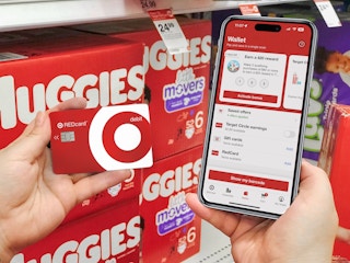 someone holding up their Target RedCard next to a phone displaying the Target app