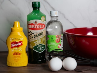 Ingredients to make mayo at home; mustard, oil, vinegar, two eggs