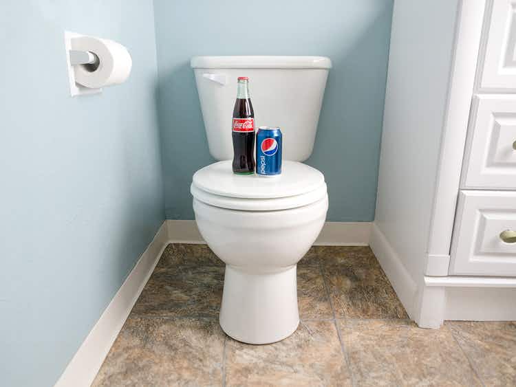 bottle and can of pepsi and coca-cola on toilet for cleaning hack