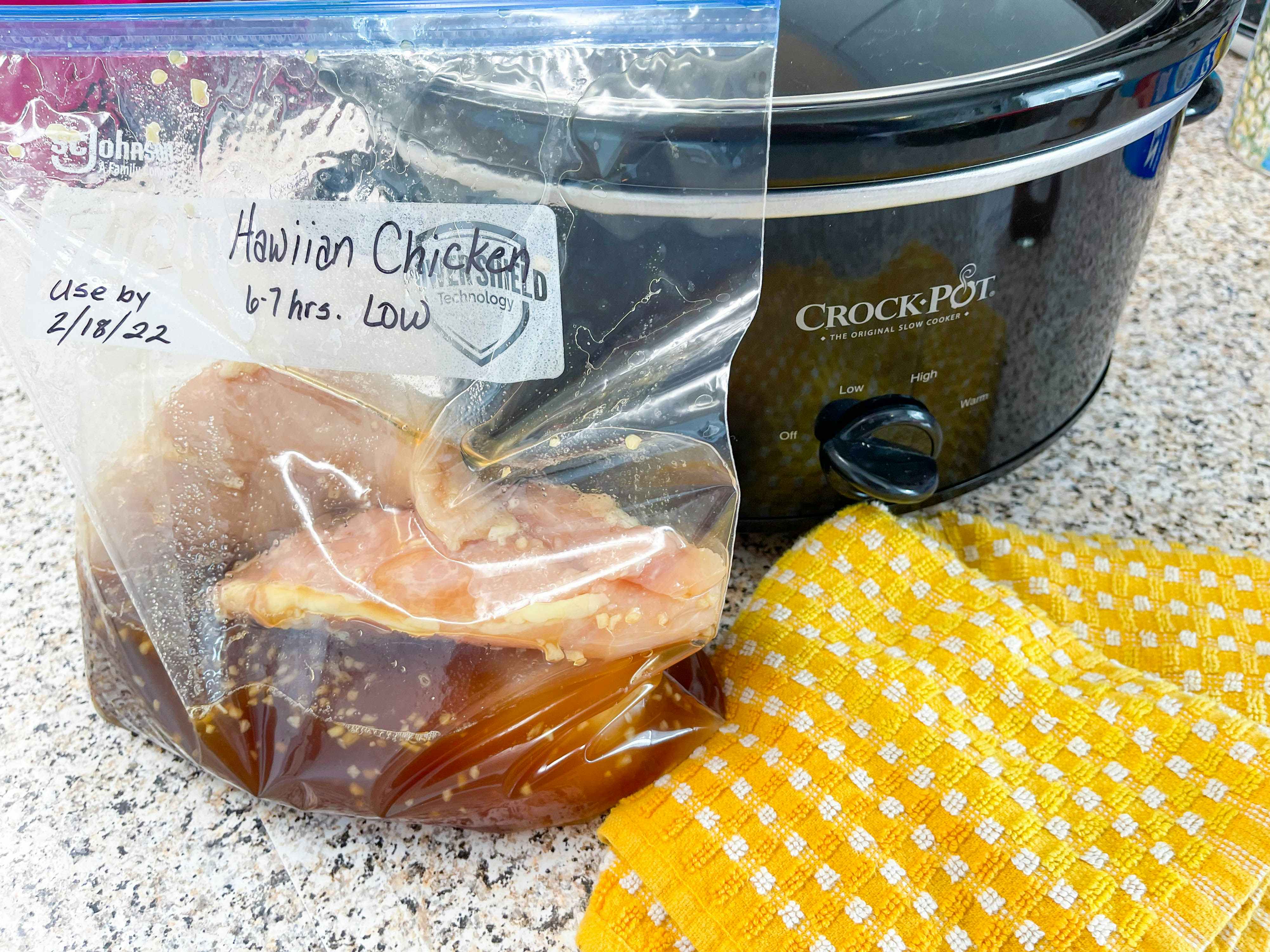 Ziploc bag with a freezer meal next to a crockpot