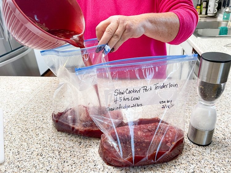 woman putting ingredients in a ziploc bag