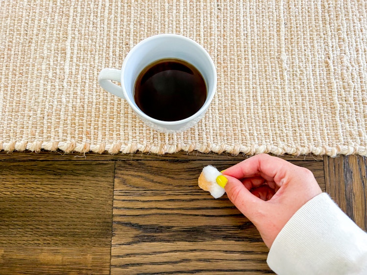 a person removing wood scratches with coffee