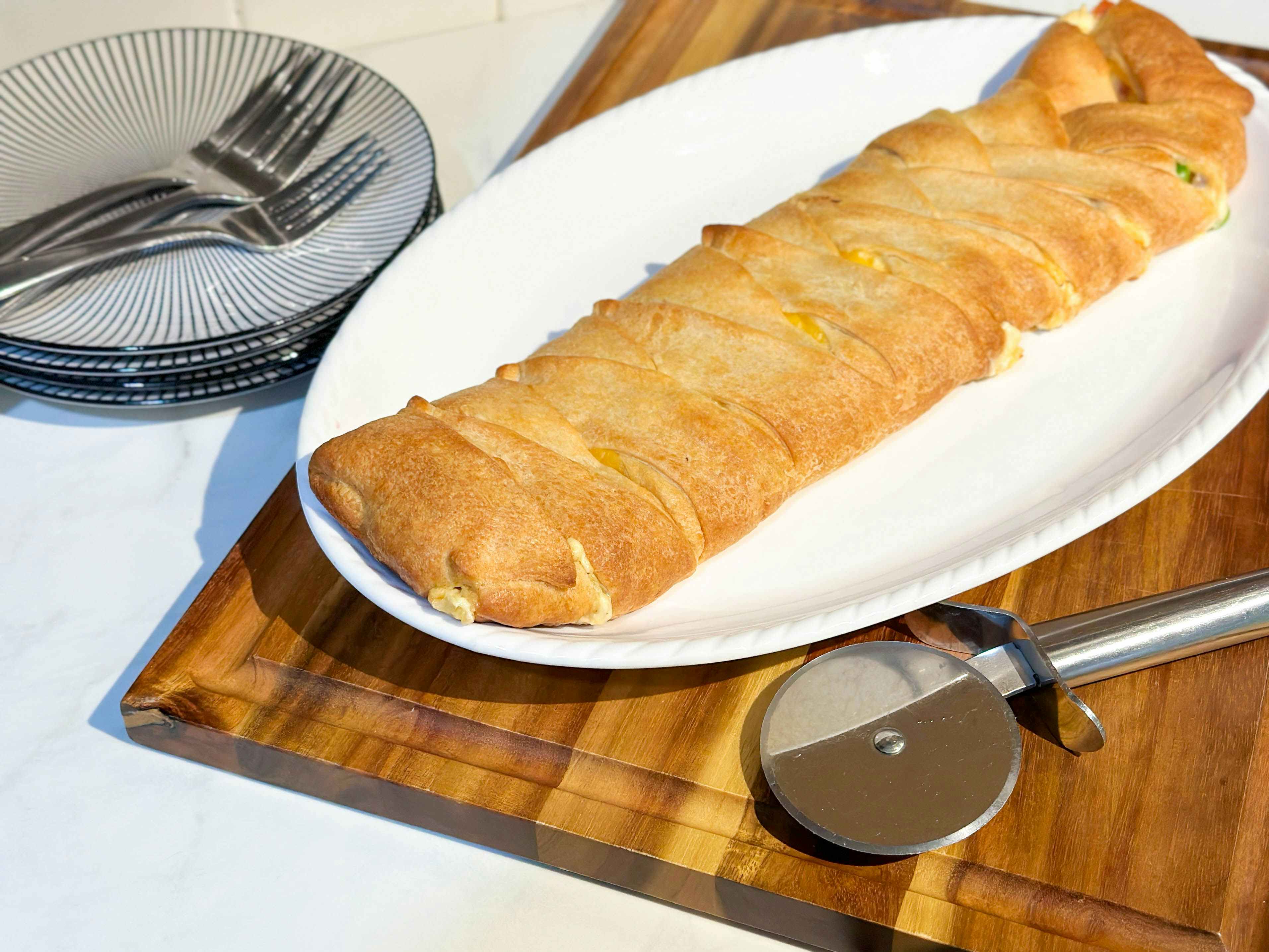 a chicken braided crescent roll meal on a cutting board