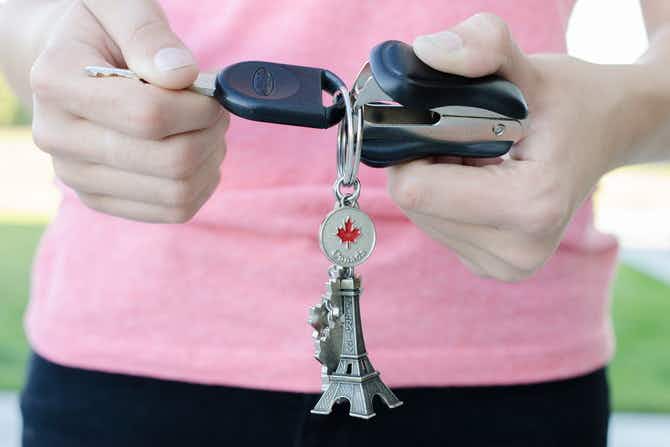 Pry open a key ring with a staple remover.