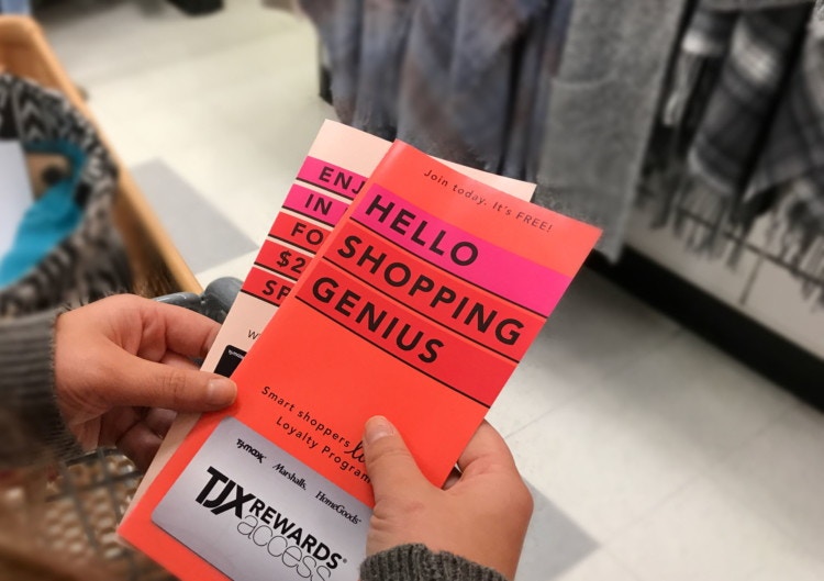 a woman holding brochures for the TJX rewards credit card