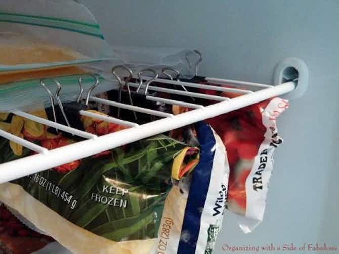 Fridge & Freezer Hacks: Make more room in a freezer by clipping opened bags underneath a shelf.