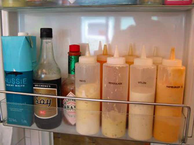 Fridge & Freezer Hacks: Decrease visual clutter by transferring condiments to matching squeeze bottles.