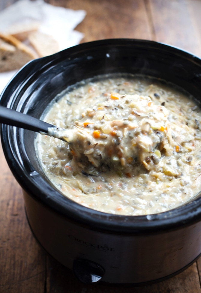 A creamy soup with rice and vegetables in a slow cooker