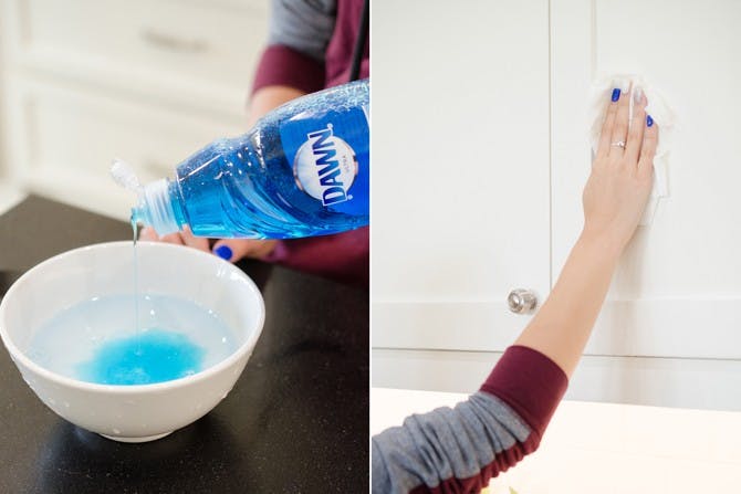 A person cleaning cupboards with dawn dish soap.