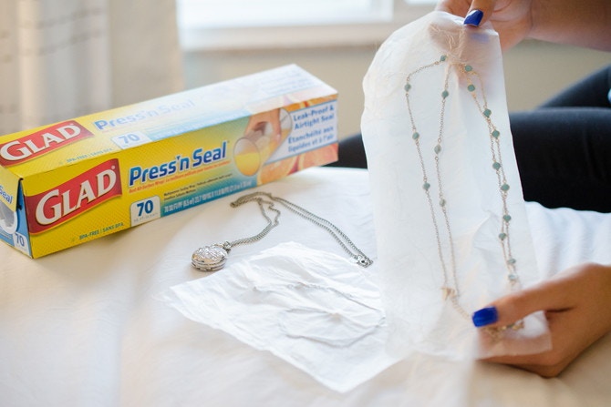 woman putting a gold necklace in glad press'n seals
