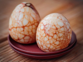 Hard-boiled eggs with marbled food coloring patterns on them.