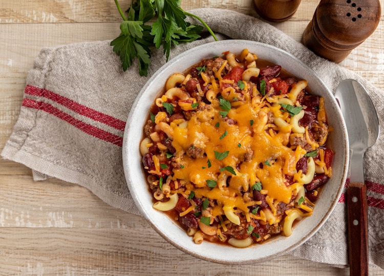 a bowl of chili mac and cheese served in a bowl
