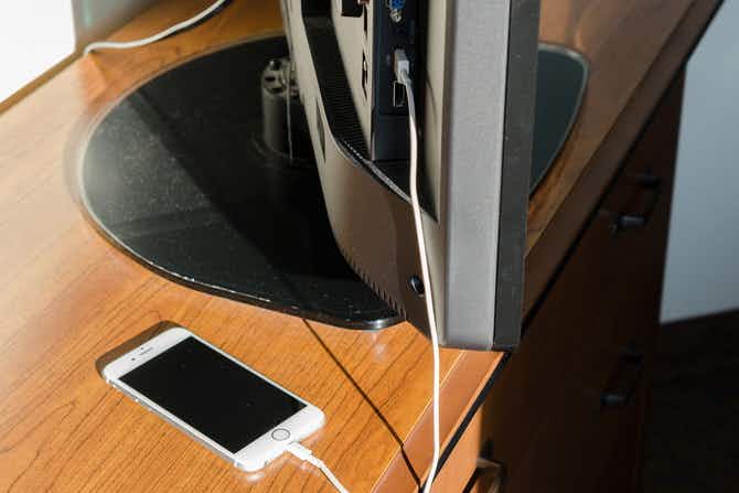 A phone attached to a TV by usb cord
