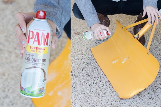 A person spraying Pam on a snow shovel 