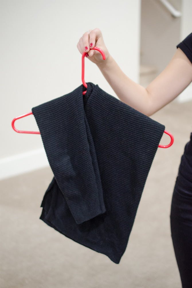 Hanging sweaters like this will prevent them from falling off or getting stretched out.