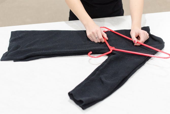 Hanging sweaters like this will prevent them from falling off or getting stretched out.