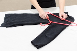 Hanging sweaters like this will prevent them from falling off or getting stretched out.