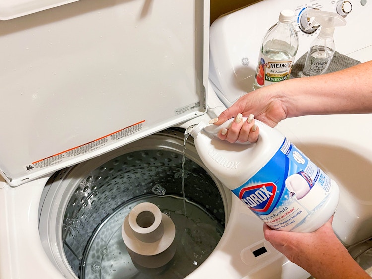 pouring bleach into washer