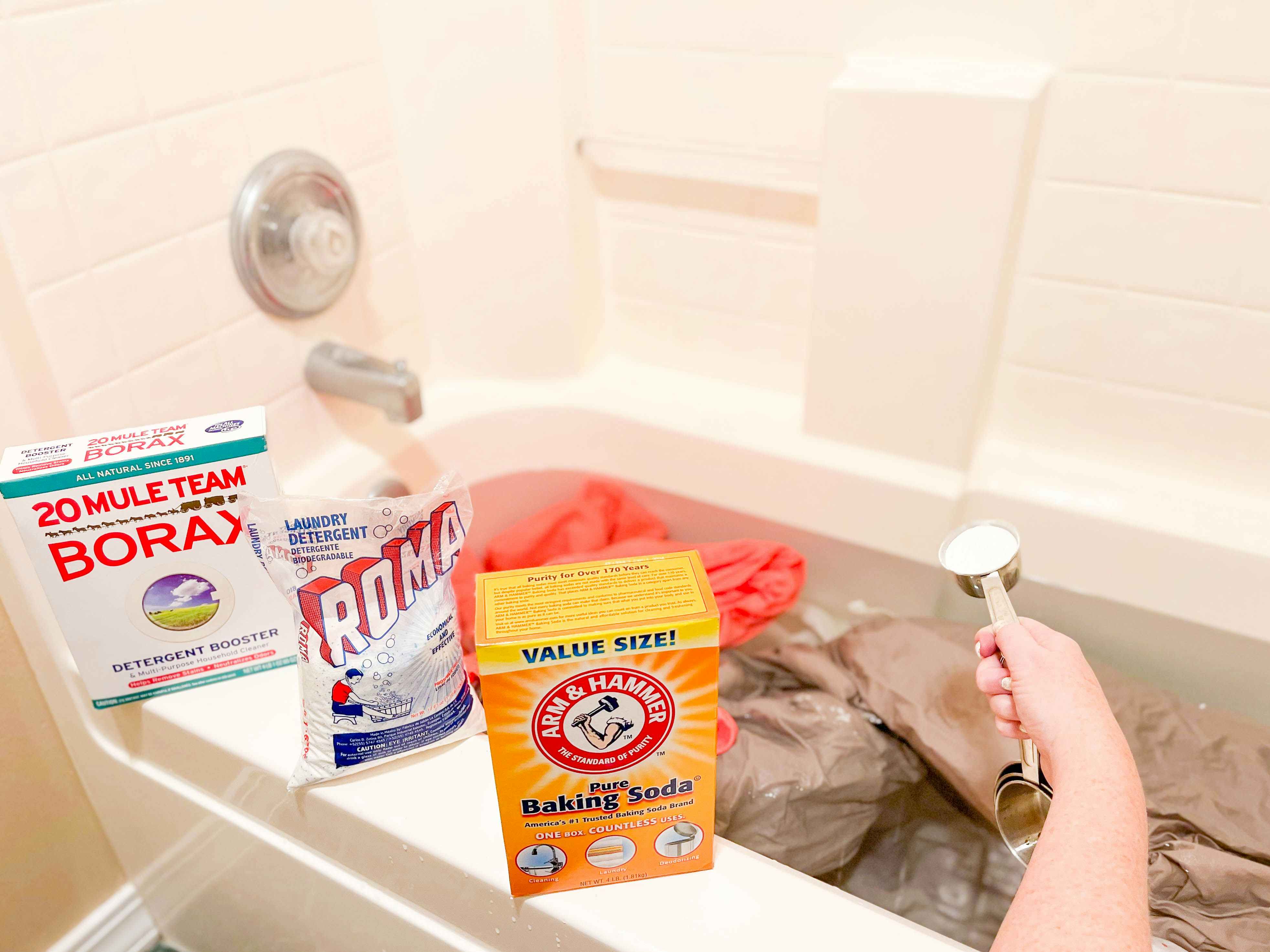 bath tub filled with water and laundry with cleaning products to strip laundry
