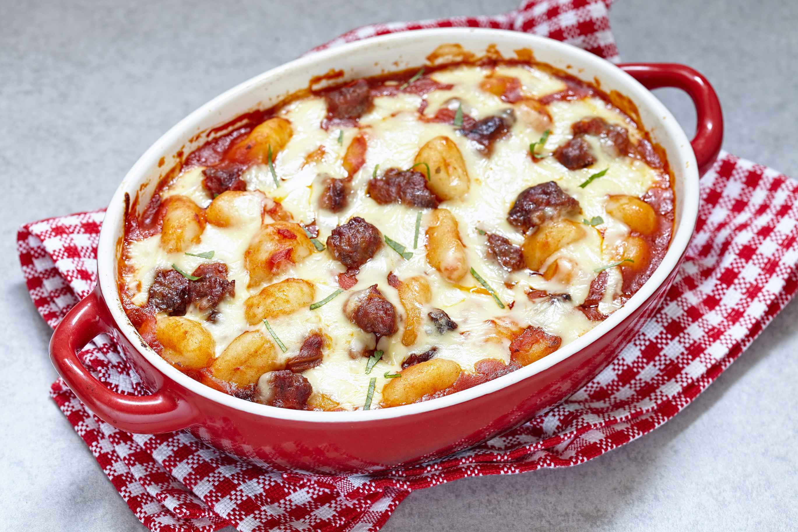 An italian sausage gnocchi bake in a pan on a table