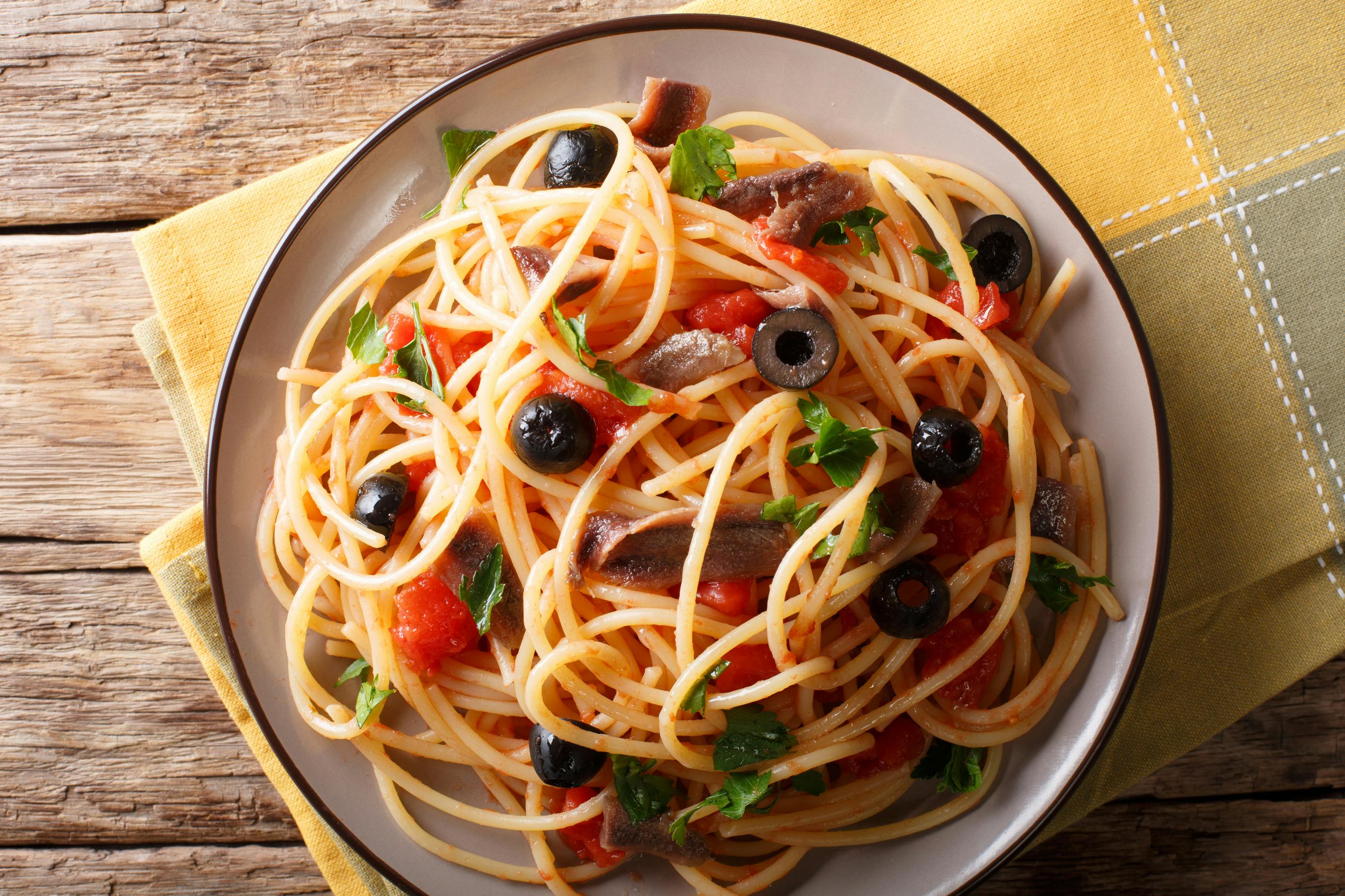 A plate of puttanesca spaghetti