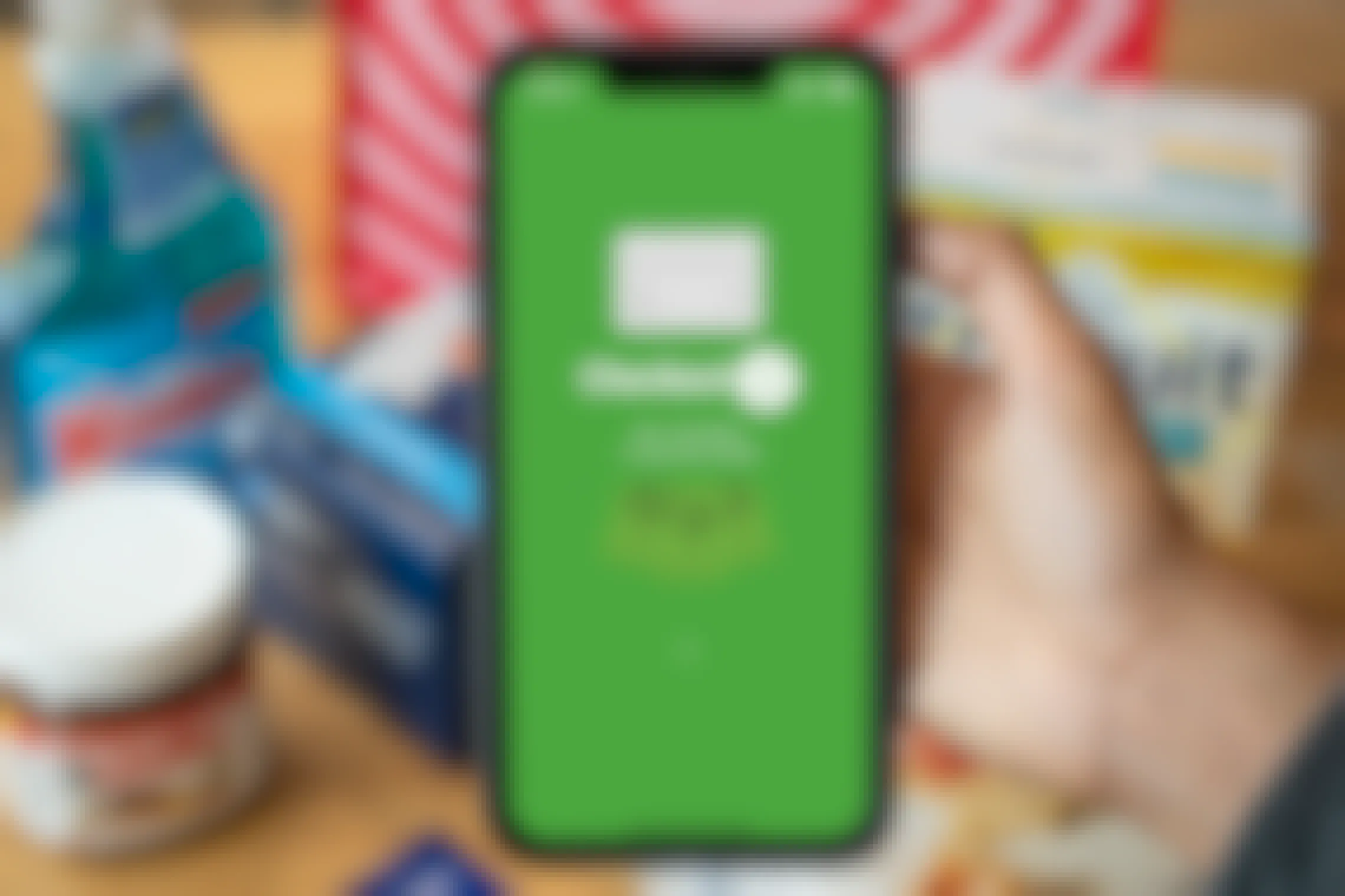 The Checkout51 app on an iphone w/ groceries and a target grocery bag in the background.