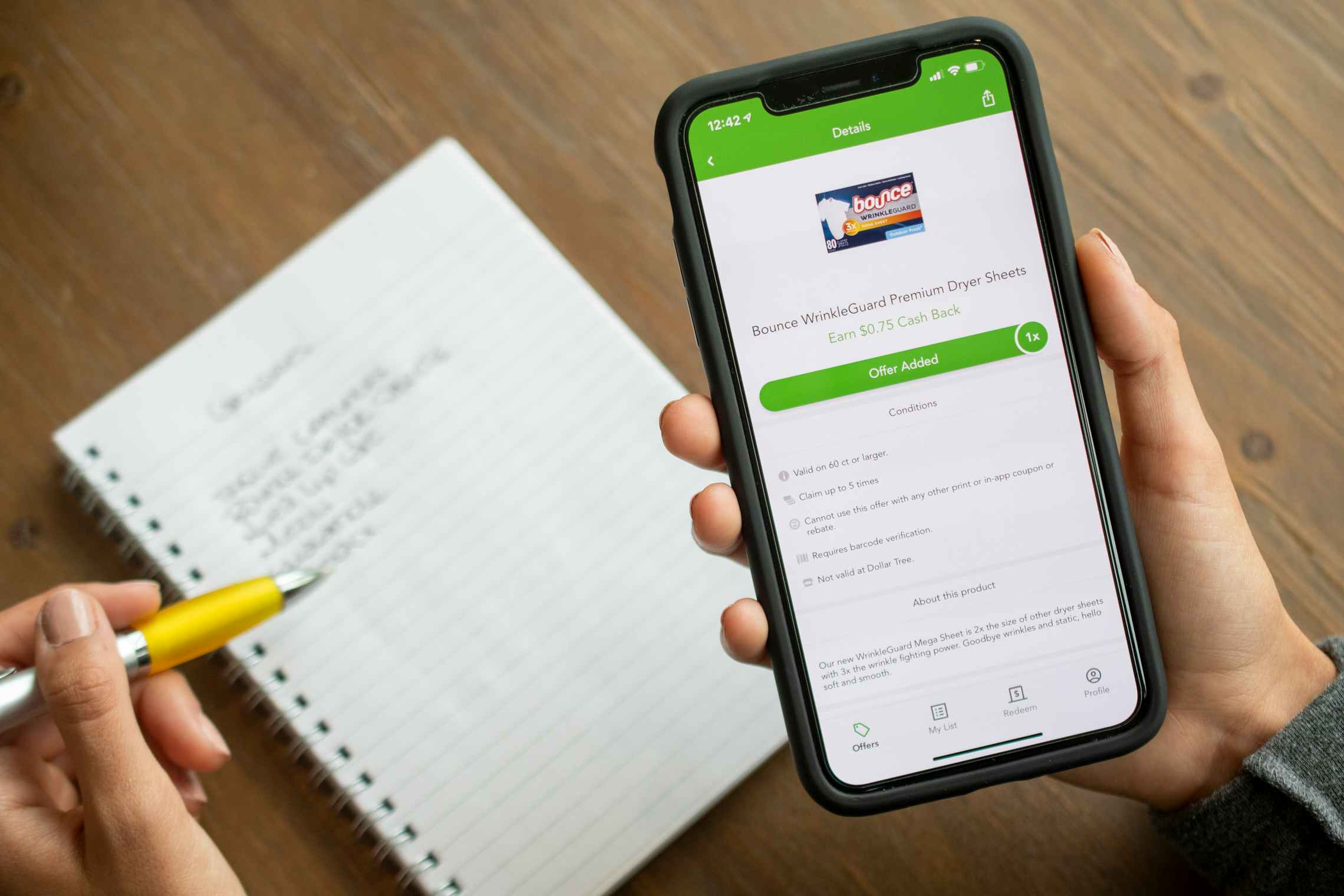 The checkout 51 app, with a deal for dryer sheets open and a grocery list on the table behind it.