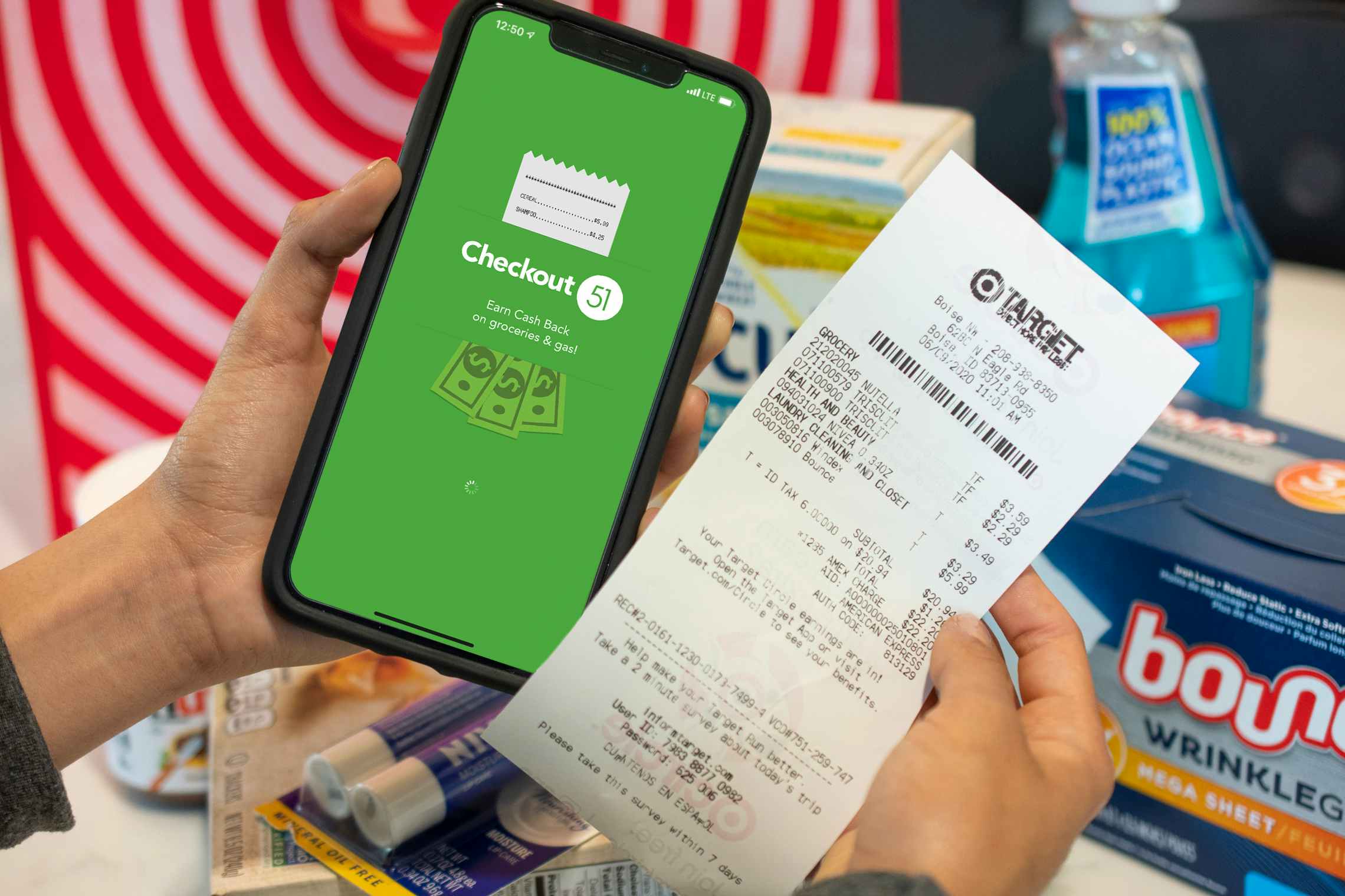 A person holding a receipt in one hand, and an iPhone displaying the Checkout51 app in the other.