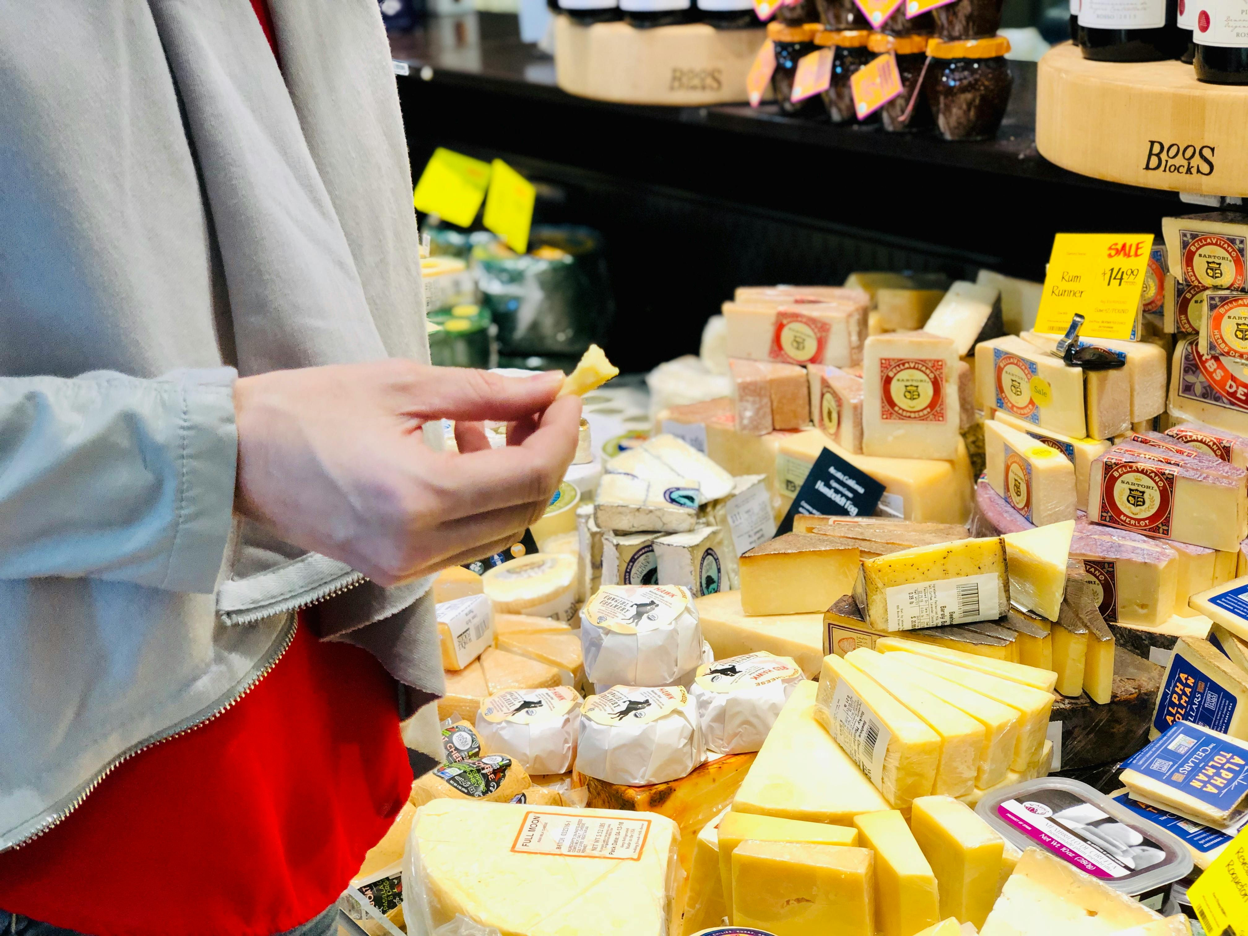 A woman sampling cheese at whole foods