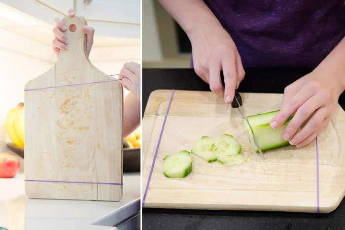 Keep a cutting board from slipping with rubber bands.